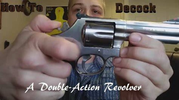 What does cocking a revolver do?